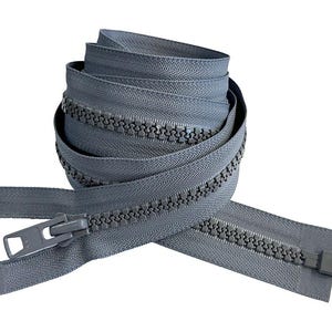 May include: A gray zipper with a plastic slider. The zipper is coiled and ready to be used for sewing projects.