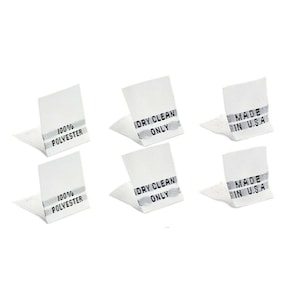 May include: Six white fabric labels with black text. The labels read "100% Polyester", "Dry Clean Only", and "Made in U.S.A."