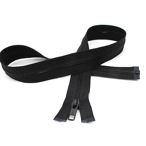 May include: A black zipper with a metal slider. The zipper is closed and lying on a white background.