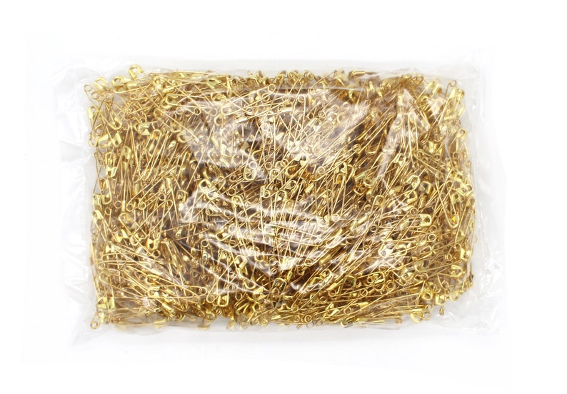 May include: A clear plastic bag filled with a large quantity of gold safety pins.