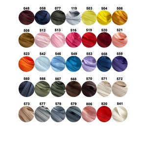 May include: A color chart of zipper tape samples. The chart includes a variety of colors, including red, blue, green, yellow, orange, and brown. The zipper tape samples are arranged in rows and columns.
