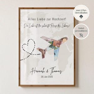 May include: A framed print featuring a world map backdrop and a paper airplane design constructed from banknotes. The print includes the text "Alles Liebe zur Hochzeit!" and "Die Liebe ist die schönste Reise des Lebens!" with the names "Hannah & Thomas" and the date "28. Juni 2025".