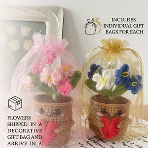 May include: Two crocheted potted plants with smiling faces, each holding a red heart. One plant has pink flowers in a pink organza bag, and the other has blue and white flowers in a gold organza bag. Text includes INCLUDES INDIVIDUAL GIFT BAGS FOR EACH.