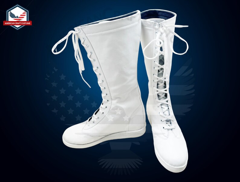 May include: A pair of white wrestling boots with laces up the front. The boots have a flat sole and are made of a smooth leather-like material.