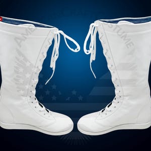 May include: A pair of white wrestling boots with blue lining and laces. The boots are tall and have a lace-up design.