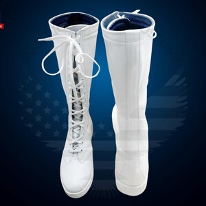 May include: A pair of white knee-high boots with lace-up fronts. The boots have a blue lining at the top.