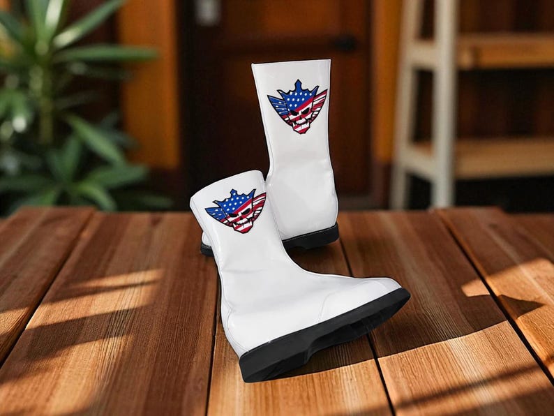 May include: A pair of white boots with a black sole, featuring a graphic of a skull with a blue and red American flag design. The boots are made of a glossy material and are displayed on a wooden surface.