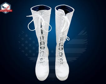 May include: A pair of white leather lace-up boots with a blue lining. The boots are tall and reach above the ankle.