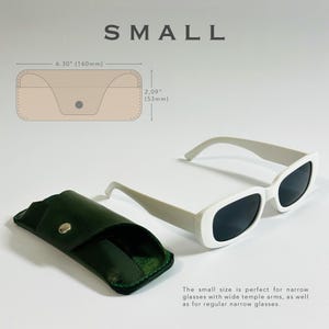 K&ouml;nnte beinhalten: Ein wei&szlig;es Leder-Brillenetui mit einem gr&uuml;nen Lederetui, das darin gefaltet ist. Das wei&szlig;e Etui misst 16 cm x 5,3 cm. Der Text "SMALL" befindet sich oben im Bild.