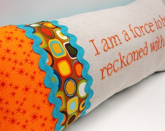 Hand-embroidered pillow  "I am a force to be reckoned with." in orange, turquoise, brown