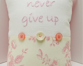 pillow, hand-embroidered pillow ''never give up'' in pink floss on white linen with pink and cream toile floral and buttons -Ready to ship