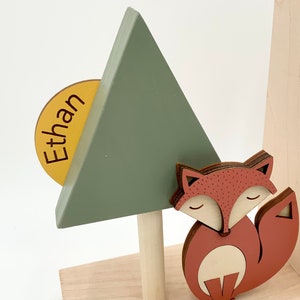 Little wooden fox with pine tree and name on sun