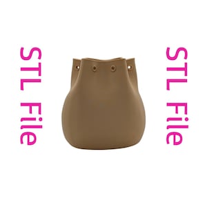 May include: A tan-colored, drawstring bucket bag. The bag has a rounded base and a cinched top with eyelets. The words "STL File" are printed vertically on either side of the bag in pink.