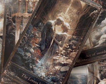 May include: A collection of tarot cards featuring intricate dark gold and black ornate borders. The central card displays The Lovers VI with two figures embracing amidst flowers. Other visible cards include Ace of Swords and Strength VIII.