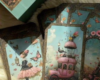 May include: Two tarot cards with ornate gold frames and colorful illustrations. The card on the left shows a girl in a pink dress holding a birdcage with a bird inside. The card on the right shows a pink carriage with a bird on top. The card on the left is labeled "7 of cups" and the card on the right is labeled "the Chariot VII".