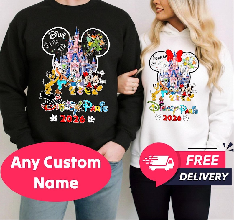 May include: Black sweatshirt with a Disney design featuring Mickey and Minnie Mouse, a castle, and the text "Disney Paris 2026". A white hoodie with a similar design is also shown. The design is in the shape of Mickey Mouse's head.