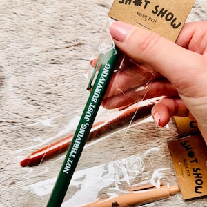 Funny Swear Pen: Sarcastic Novelty Stationery - Sh*t Show , Rude Pens, Coworker Gift, Black Ink, Fun Gag Gift, Individually Packed, Stocking
funny rude pens
mean pen gift
sweary teacher gift
rude but funny pens
desk humour items
sarcastic gift
novelty supplies
snarky stationery
sarcastic
back to school
sassy gifts
coworker present
cheeky pen