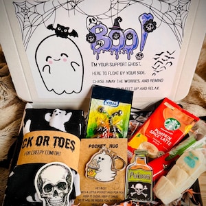 May include: A Halloween-themed gift box containing black socks with white ghosts, a Vidal candy pack, a Starbucks Pumpkin Spice Latte mix, a skull sticker, a Poison bottle sticker, a ghost keychain labelled Pocket Hug, and a white ghost-shaped treat.