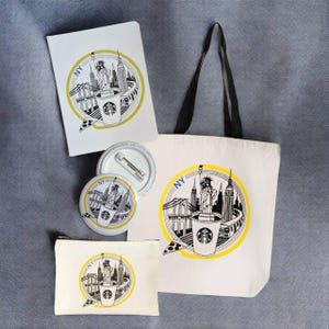 May include: A collection of New York-themed merchandise featuring a Starbucks coffee cup design. Includes a tote bag, notebook, zippered pouch, and two pinback buttons. The design incorporates the Statue of Liberty, skyscrapers, and the text "NY" in a yellow and black color scheme.