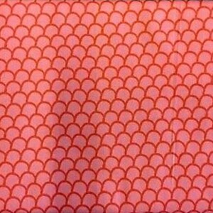 May include: Pink fabric with a red scale pattern.