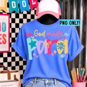 May include: A blue t-shirt featuring the colorful text "so God made a para" with graphic elements including a star, a bow, and flowers. The shirt is displayed on a mannequin wearing a pink and white baseball cap. The text "PNG ONLY!" is visible.
