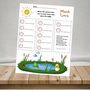 May include: A worksheet with the title "Math time" featuring clocks and a riddle. The worksheet has a sun illustration and a pond scene with a frog, duckling, ladybug, and butterflies. The text reads "Write the correct time next to each clock, then solve the riddle."