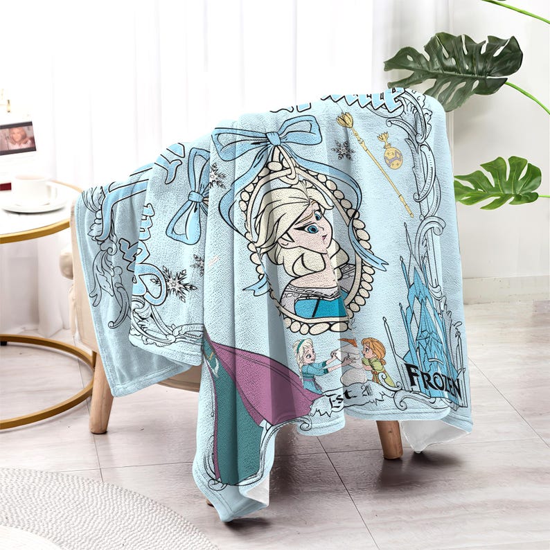 May include: A light blue fleece blanket featuring Elsa from the movie Frozen. The blanket has a decorative border with snowflakes and the word "Frozen". The design includes Elsa's portrait and other characters.
