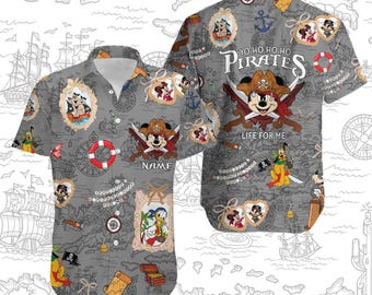 May include: A gray and white button-up shirt with a tropical print featuring Mickey Mouse, Donald Duck, and Goofy dressed as pirates. The shirt has the text "Yo ho ho ho Pirates Life for me" on the back.