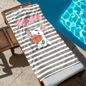 May include: A gray and white striped beach towel with a cartoon pig wearing a pink shirt and holding a bowl of food. The text "Your name" is written in pink on the towel.