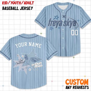 May include: Light blue baseball jersey with vertical stripes, featuring the text "freya skye" and the number "00" on the front. The back displays "YOUR NAME" and a graphic with the text "Silent Treatment" and "FREYA SKYE".
