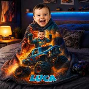 May include: A soft plush blanket featuring a vibrant graphic of a blue monster truck with large tires and flames, with a child's face integrated into the design. The name LUCA is printed in large blue letters at the bottom of the blanket.