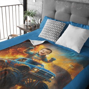 May include: A soft fleece blanket featuring a vibrant, colorful illustration of a joyful child with arms raised, riding in a blue monster truck. The background depicts a fiery, explosive scene with bright orange and yellow flames and dark smoke.