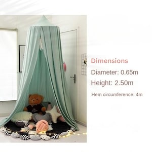 May include: A mint green canopy with a diameter of 2.13 feet and a height of 8.2 feet. The hem circumference is 13.12 feet. The canopy is draped over a black mat with decorative pillows and a teddy bear inside.