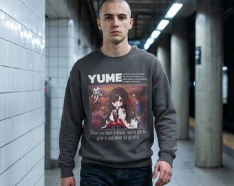 May include: Dark gray sweatshirt featuring the word "YUME" and Japanese characters. Below is an anime-style illustration of a girl with long brown hair. The text "When you have a dream, you've got to grab it and never let go of it." is also printed on the sweatshirt.