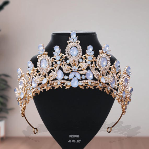 Elegant Gold and Blue Gemstone Tiara Elegant Golden Crown with Blue Gemstones on Dark Fabric  main image 2