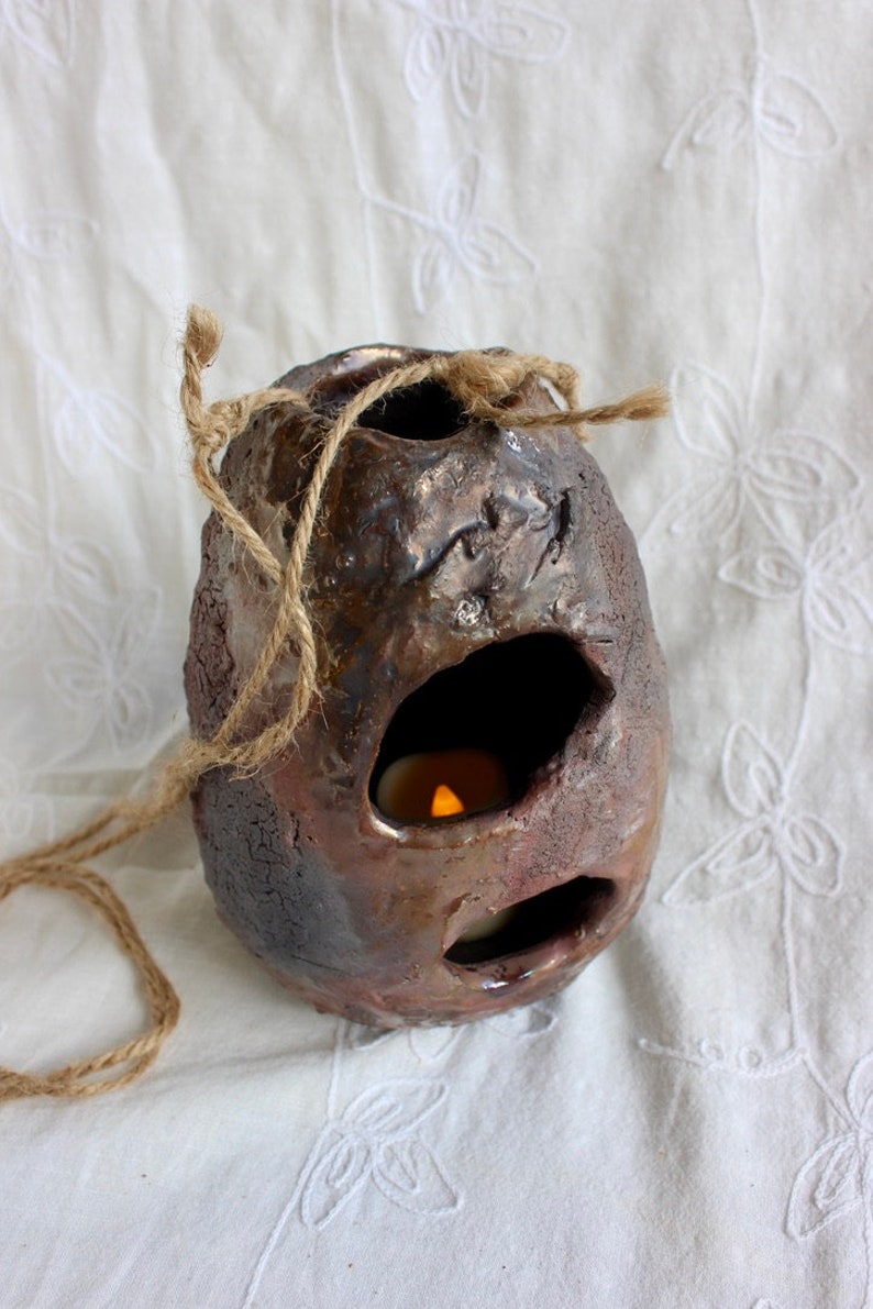 Outdoor decor, bird’s nest, candleholder, pottery, handmade, stoneware, Raku, iridescent blues, golds, greens, reds, 6"h x 4 1/2” w x 2 1/2" bild 1