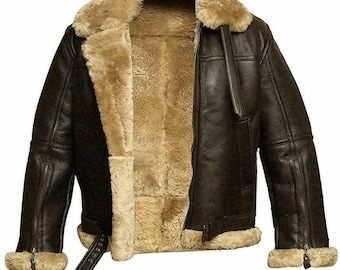 May include: A brown leather bomber jacket with a shearling lining and collar. The jacket has a zipper closure and two pockets on the front.