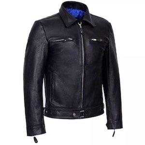 Puede incluir: Una chaqueta de cuero negra con cierre de cremallera y múltiples bolsillos. La chaqueta tiene un cuello de pie y un cinturón en la cintura.