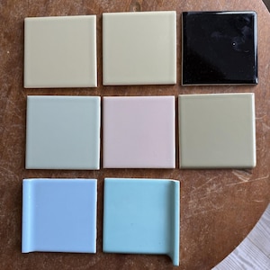 May include: Nine square ceramic tiles in various pastel colors, including light green, pink, blue, and a glossy black. The tiles are arranged in a grid pattern, showcasing a range of hues suitable for home decor projects.