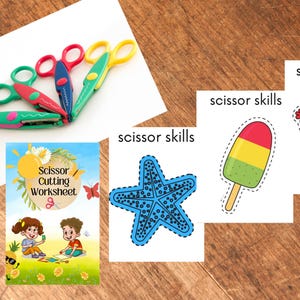 Könnte beinhalten: Eine Sammlung bunter Scheren und ein Arbeitsheft "Scissor Cutting Worksheet". Das Arbeitsheft zeigt Illustrationen von Kindern und den Text "Scissor Cutting Worksheet". Ebenfalls enthalten sind ausgeschnittene Bilder eines Seesterns, eines Eis am Stiel und eines Kaktus, jeweils mit der Aufschrift "scissor skills".
