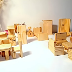 May include: A set of wooden dollhouse furniture, including a bed, couch, chairs, a table, a stove, a refrigerator, a wardrobe, and a TV. The furniture is all made of unfinished wood and is ready to be painted or stained.