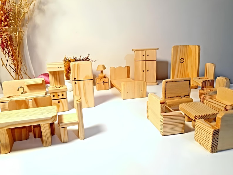 May include: A set of wooden dollhouse furniture, including a bed, couch, chairs, a table, a stove, a refrigerator, a wardrobe, and a TV. The furniture is all made of unfinished wood and is ready to be painted or stained.