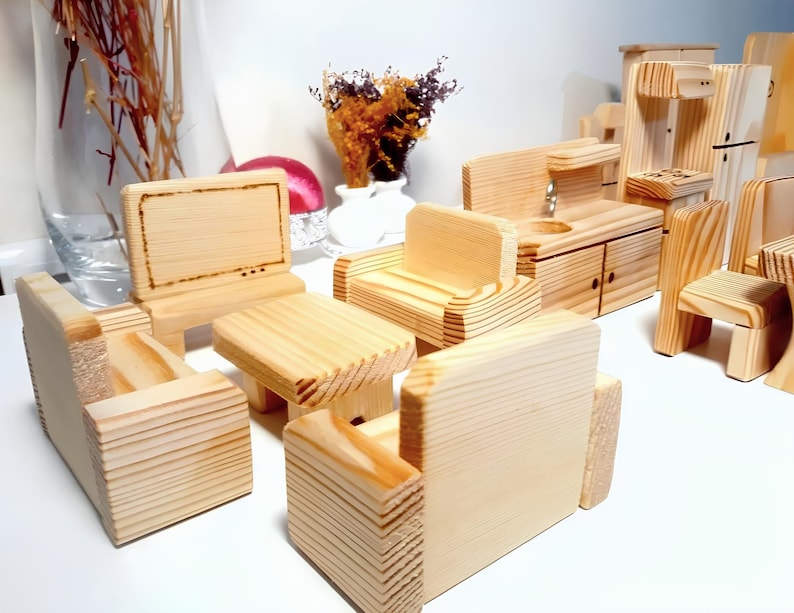 May include: A set of wooden toy furniture for a dollhouse, including a couch, a coffee table, a TV, a chair, and a kitchen set. The furniture is made of natural wood and has a rustic look.