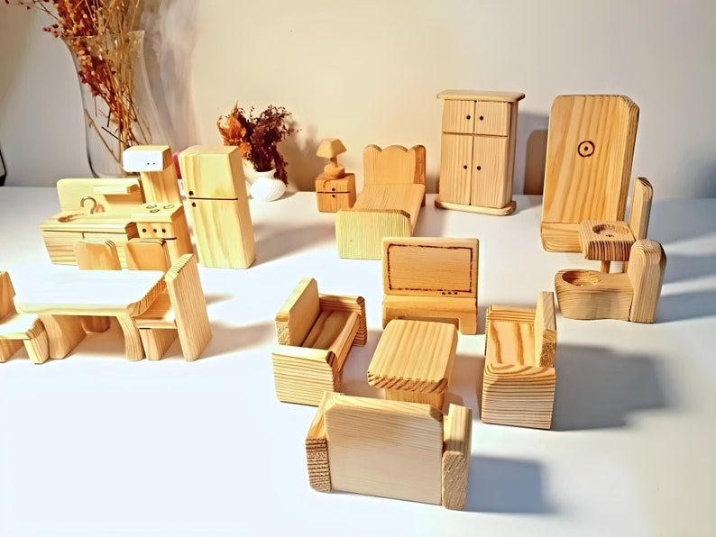 Wooden dollhouse furniture set, dollhouse kitchen furniture set,  including a bed, couch, chairs, a table, a television, a refrigerator, a kitchen sink, a toilet, and a cabinet. The furniture is made of raw wood and is ready to be painted or stained.