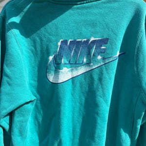 May include: A set of three ceramic mugs with a speckled, matte finish in cream, light grey, and dark grey. Each mug has a simple, minimalist design and a rounded handle.