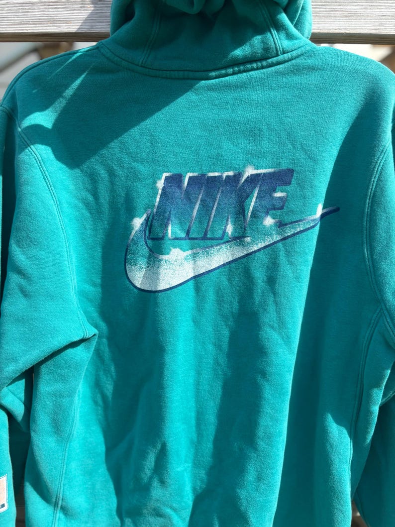 May include: A set of three ceramic mugs with a speckled, matte finish in cream, light grey, and dark grey. Each mug has a simple, minimalist design and a rounded handle.