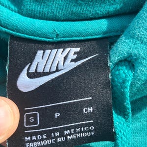 May include: A set of three ceramic mugs with a speckled, matte finish in cream, light grey, and dark grey. Each mug has a simple, minimalist design and a rounded handle.