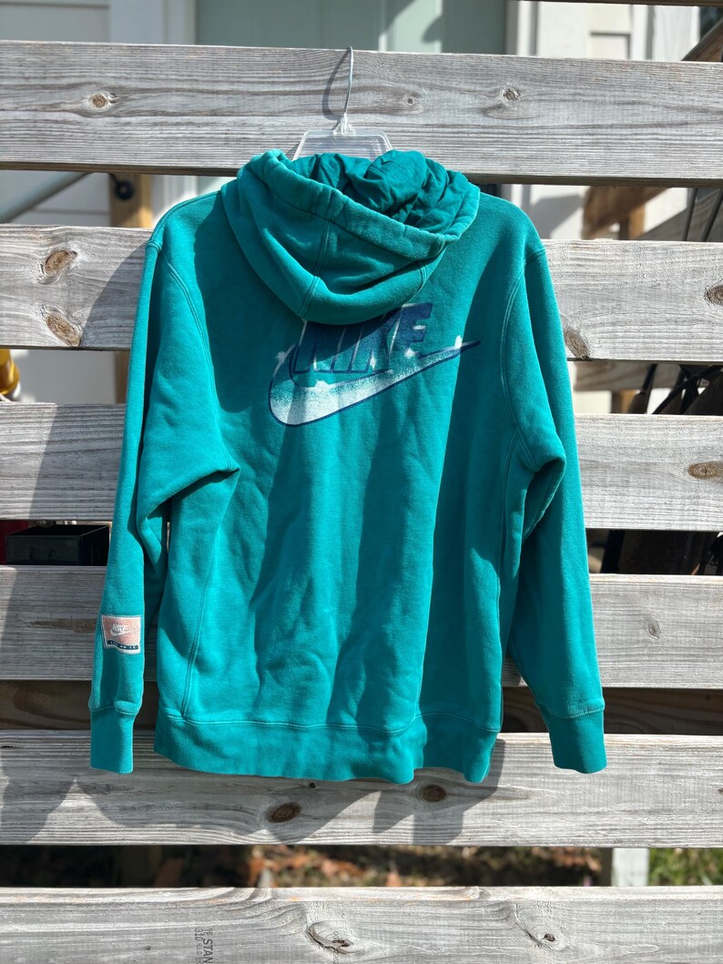 May include: A distressed wooden sign with the words "Welcome to our home" in white lettering. The sign has a rustic finish and a simple design, ideal for a front door or hallway.