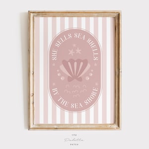 May include: A pink and white striped print with a pink circle containing the text "She Sells Sea Shells By The Sea Shore" and a pink seashell illustration.