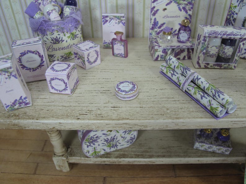 May include: A wooden shelf displaying a collection of lavender-themed items, including boxes, bottles, and rolls of wrapping paper. The shelf is decorated with a lavender floral design.